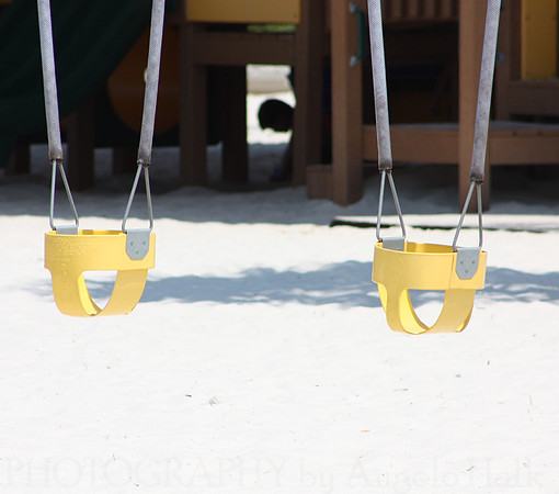 Boy Between Swings
